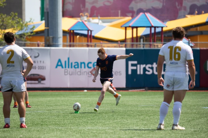 RUNY's Cathal Marsh kicking a penalty.
